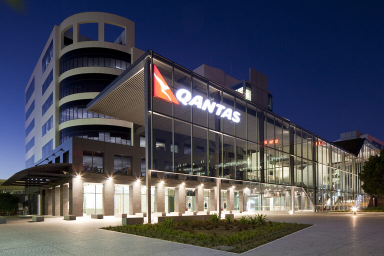 Qantas Headquarters at night with lights on
