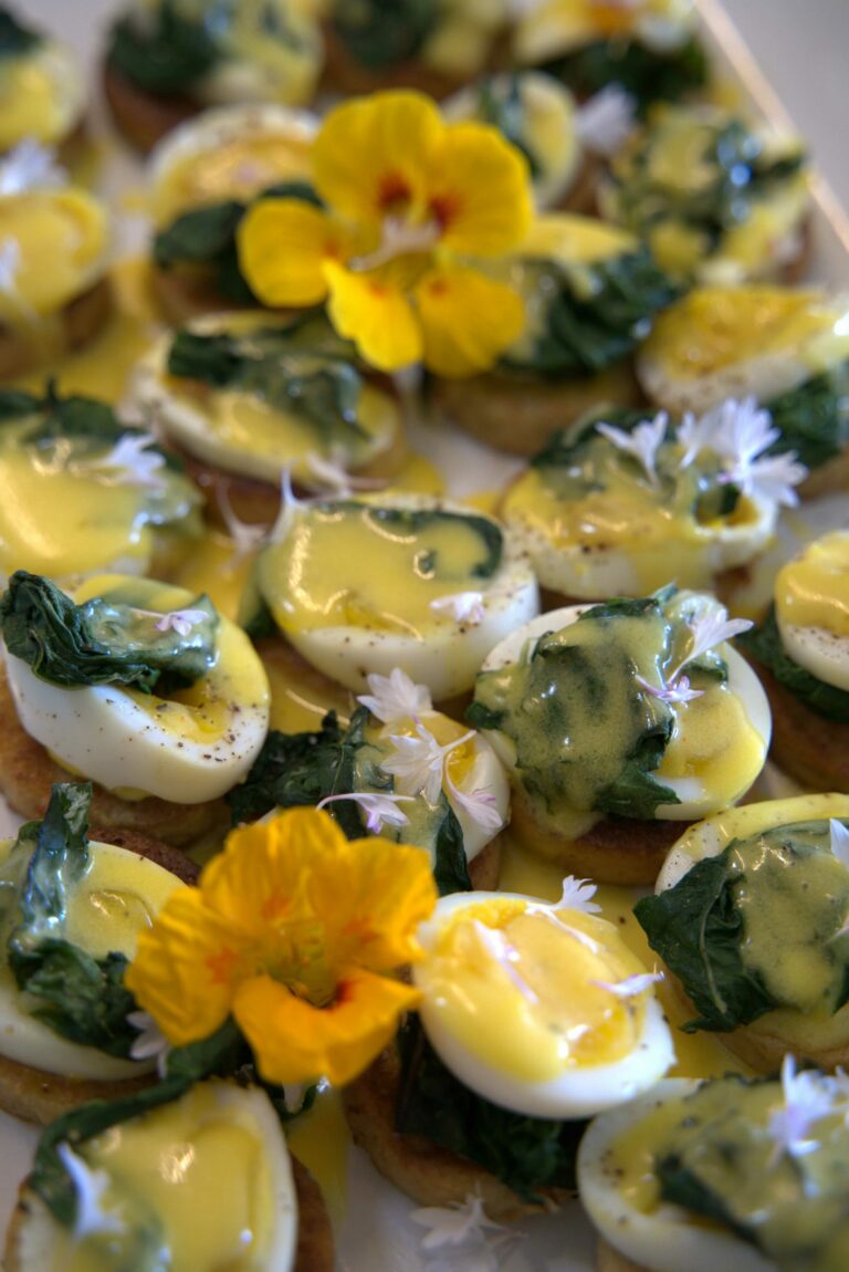 mini egg benedict's with flowers as garnish
